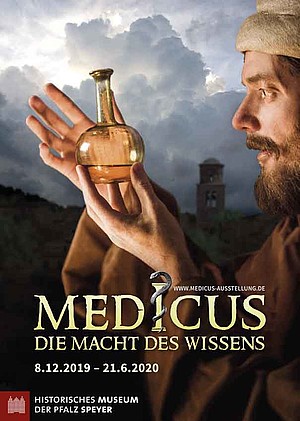 Auf dem Plakat zur Ausstellung zeigt einen Mann in mittelalterlicher Kleidung mit einer Art Reagenzglas.